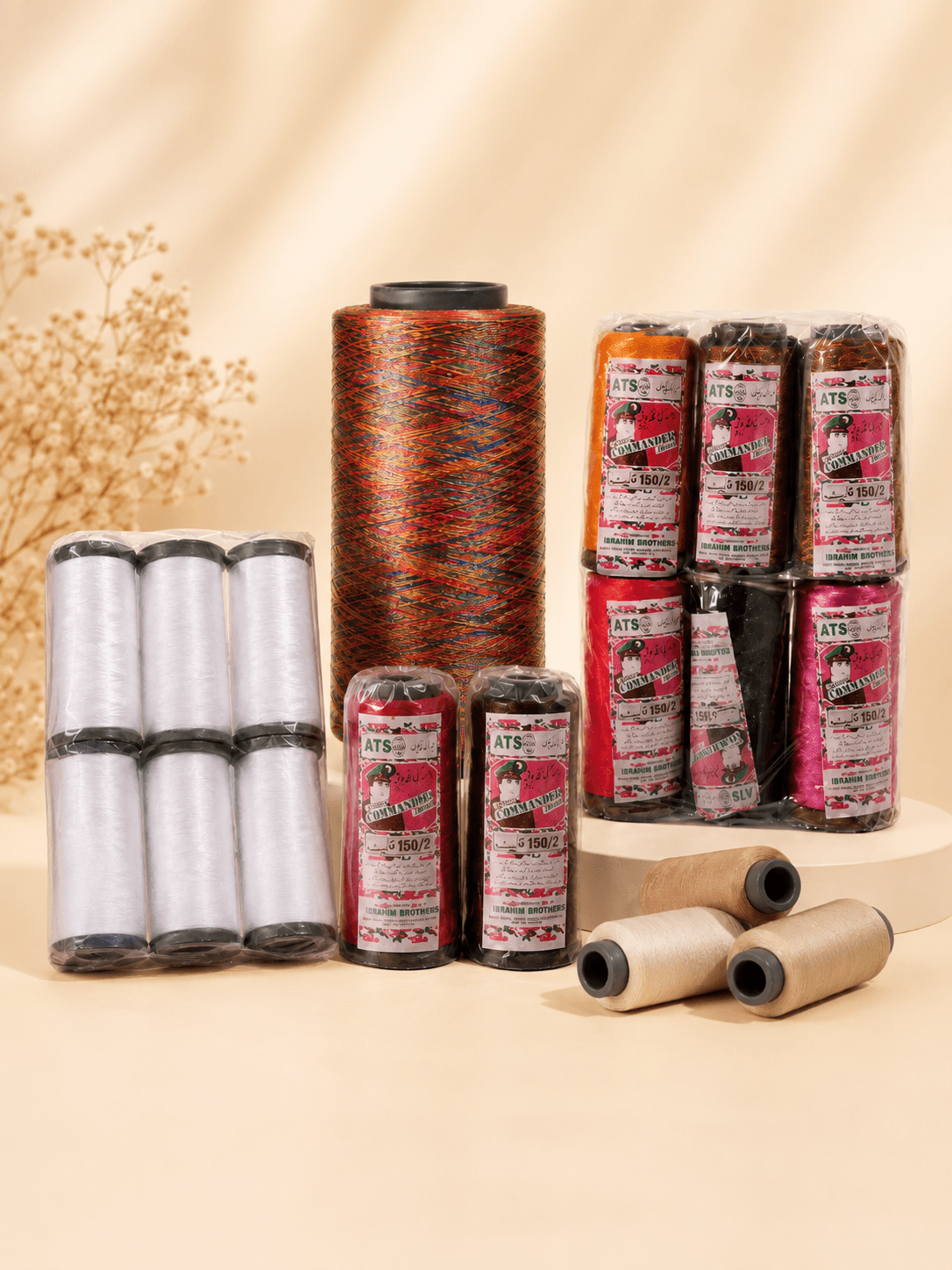 Arranged thread cones in warm, neutral studio lighting